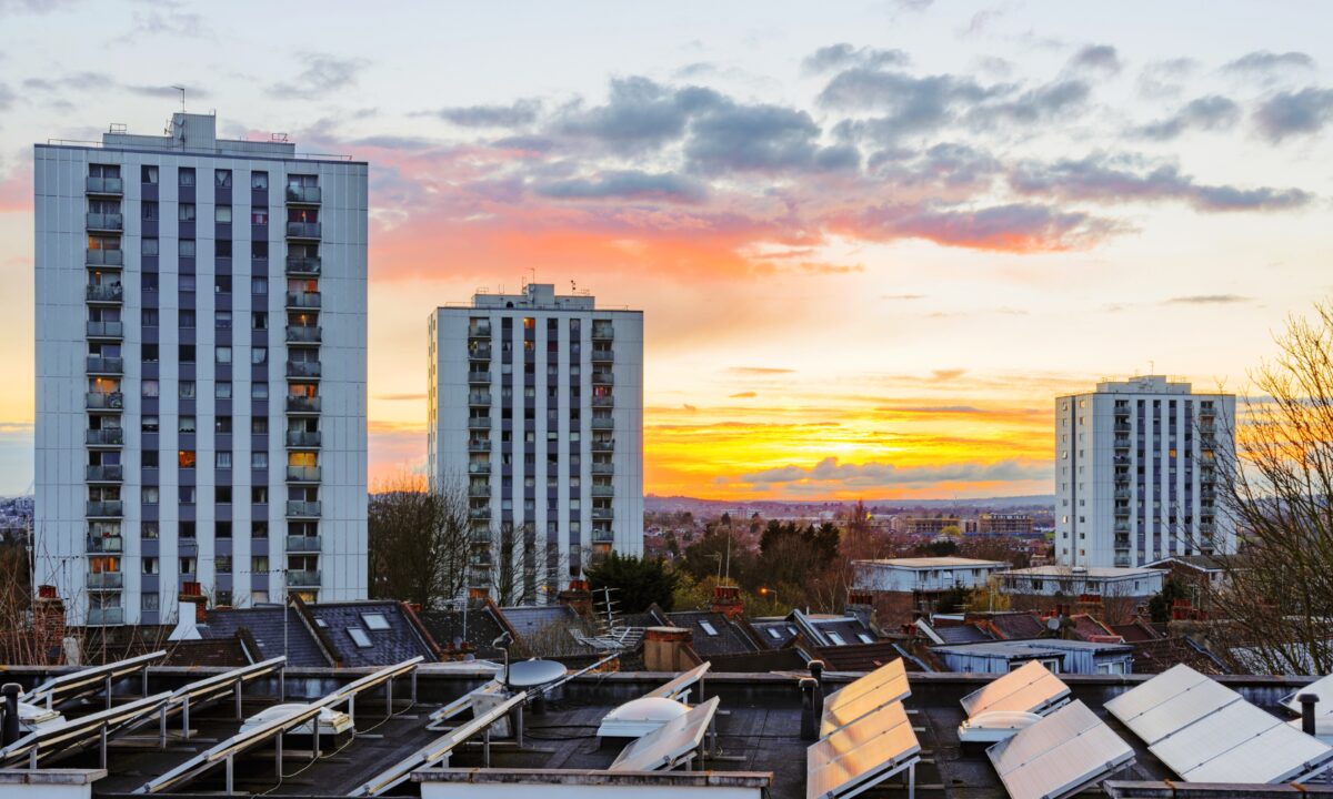 Sunset over flats solar panels housing need